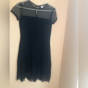 Never worn. Short black tulle dress with round neck and lace bottom.